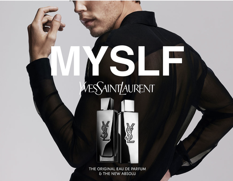 Yves Saint Laurent perfume advertisement with a man holding a black shirt.